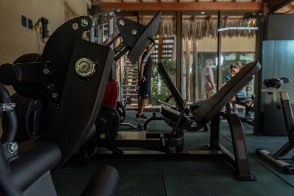A gym with exercise equipment, a weight bench, and a treadmill.