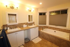A bathroom with two sinks, a bathtub, and a window with blinds. - Main House located on quiet cul-de-sac near town and walking trails to the water (Tisbury)