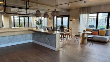 A modern interior with a kitchen island, dining area, and seating space.
