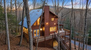 A cabin with a wooden exterior, a balcony, and a staircase leading to an upper level. - Mountain Views + Fire pit | 10 Min to BR/Yoga Room - Holiday Home (Blue Ridge)