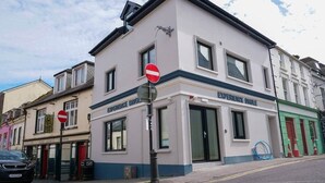 A building with a 'No Entry' sign, a shop named 'Experience Dinges,' and a car parked on the street. - Experience Dingle @ Main Street - Room 3 (Dingle)