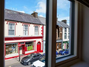A street view with a building featuring a red door and a checkered pattern on the window. - Experience Dingle @ Main Street - Room 3 (Dingle)