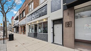 A street view with a building labeled 'Sherwood Mortgage Group' and a closed storefront with a sign for 'The Day.' - The Skylight Vault - Bright Downtown Loft Living/Pet Friendly/Short Walk to Shop (Sarnia)