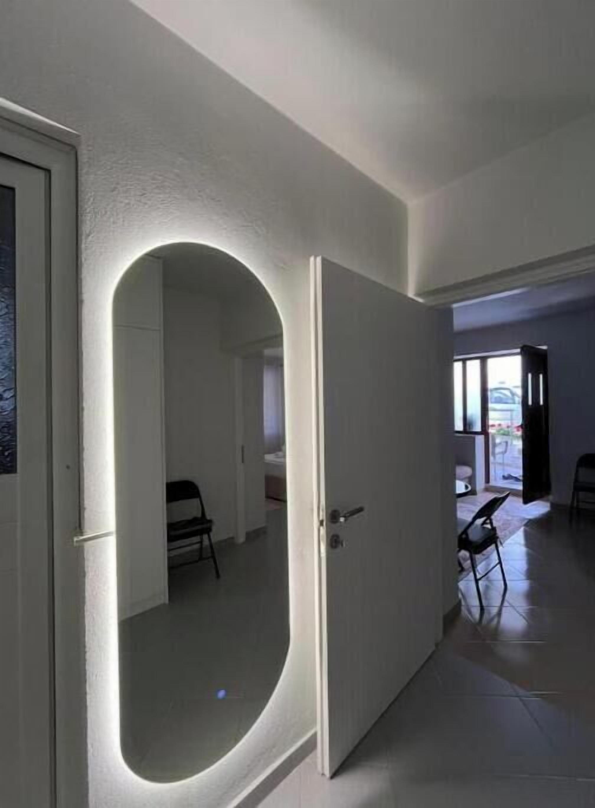 An interior hallway with a white door leading to a room.