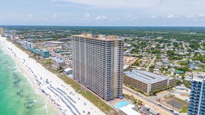 Ein Hochhaus-Hotel mit Pool, Zugang zum Strand und Meerblick.