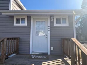 A two-story house with a white door, a small porch, and a mailbox. - Peaceful and Spacious Home With Fenced Yard - 15 Min to Madison (McFarland)