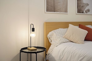 A neatly made bed with patterned bedding and a wooden headboard. - wildflower retreat (McGaheysville)