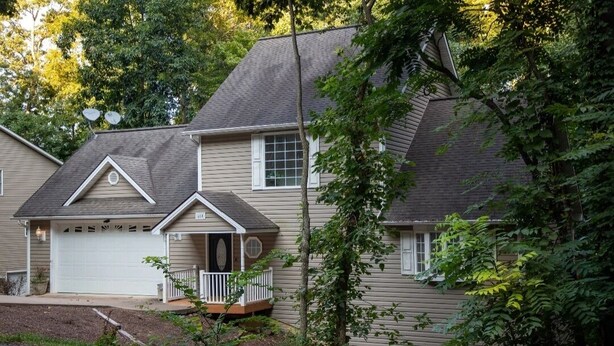 A two-story house with a garage, a front porch, and a small deck. - wildflower retreat (McGaheysville)