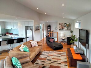 A modern apartment with a kitchen, living room, and dining area. - Comfortable  Peaceful Island Holiday Getaway (Rhyll)