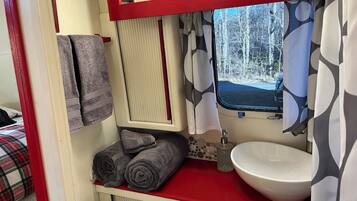 Shower, hair dryer, towels, toilet paper