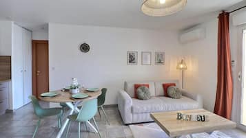 Comfort Apartment, Balcony, City View | Living area | 130-cm Smart TV with digital channels