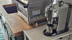 Una cucina con una macchina del caffè, un dispenser d'acqua e una banana sul bancone.