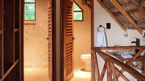 A rustic interior with a wooden staircase leading to a room with a thatched roof. - KAAJ NDOMI (Bacalar)