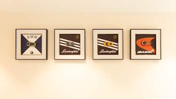 Four framed automotive logos on a wall.