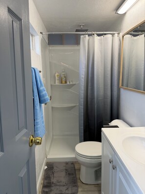 A bathroom with a shower, toilet, and vanity. - Private fenced guesthouse perfect for a couple, near Stanford, Google, Facebook (Palo Alto)