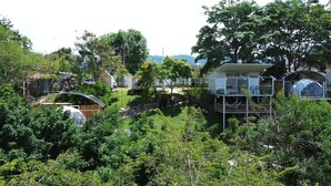 A residential area with modern houses, including a two-story house with a balcony and a dome-shaped structure.