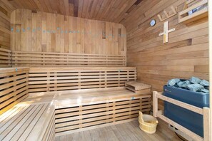 A wooden sauna with benches, a thermometer, and a bucket. - Jireh Dwellings Spacious 2Br Comfort with fitness and spacious rooms (Nairobi)