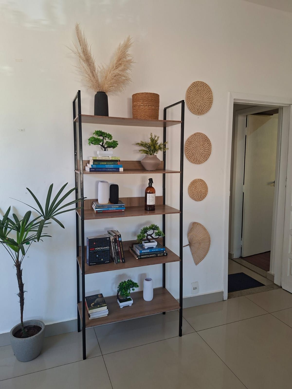 A bookshelf with various decorative items and books.