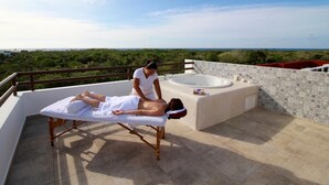 A massage therapy session on a rooftop with a view of the landscape. - Quiet, Near Beaches Cenotes, Ruins | Pool, Rooftop Hot Tub, Jungle & Ocean Views (Akumal)
