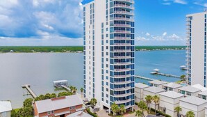 A high-rise hotel with multiple balconies, a marina, and a view of the water. - Luxury Lagoon Getaway, Corner Unit, Amazing View (Gulf Shores)