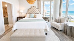 A spacious bedroom with a large bed, a sitting area, and a view of the beach. - Luxury Lagoon Getaway, Corner Unit, Amazing View (Gulf Shores)