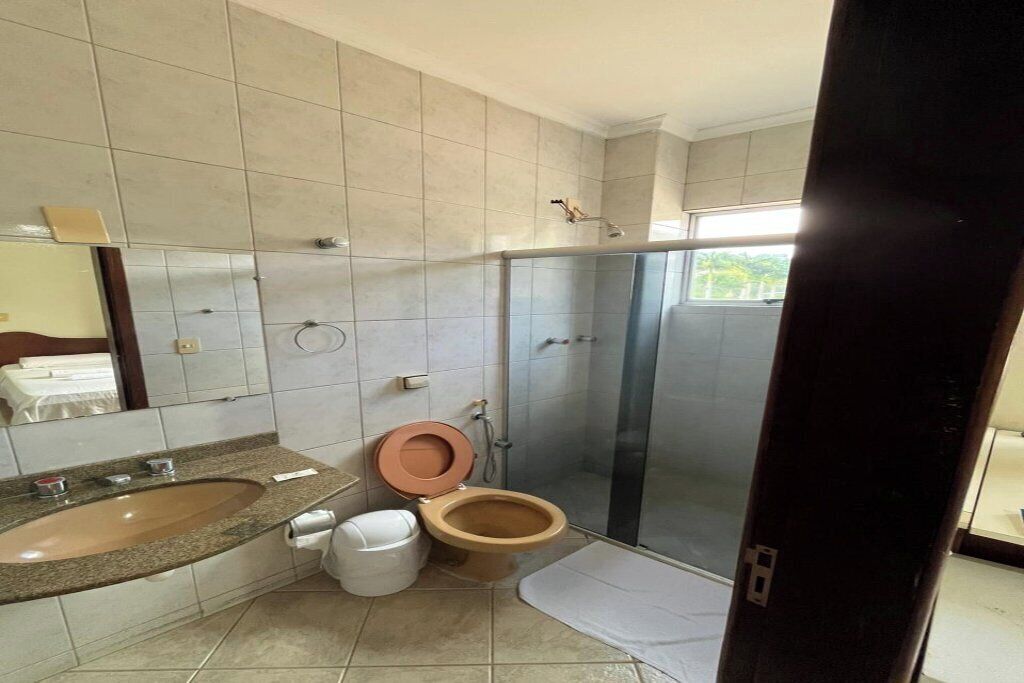 A bathroom with a sink, toilet, and shower.
