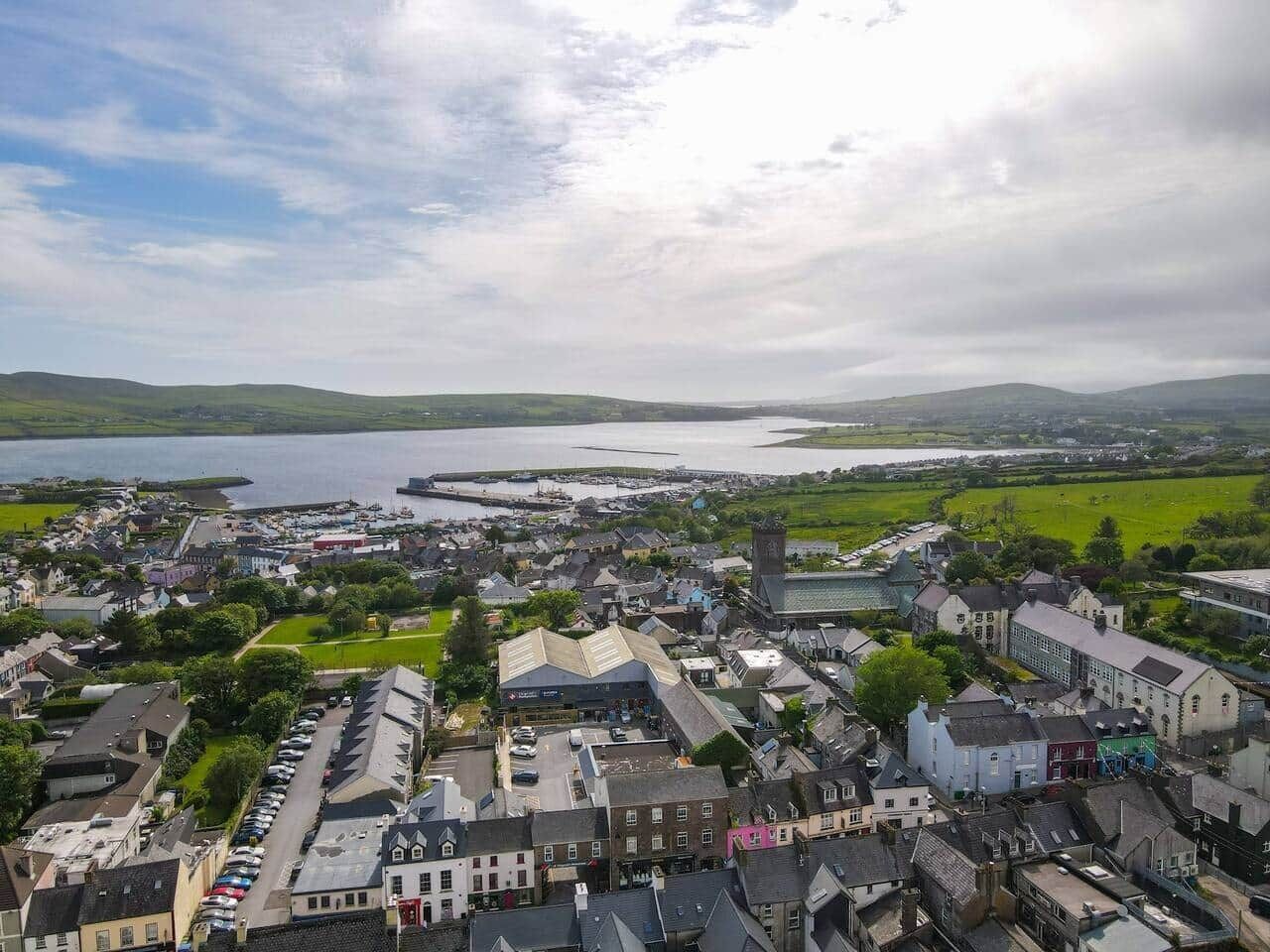 A coastal town with a mix of residential and commercial buildings, a prominent church, and a waterfront.