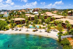 A resort with a beachfront, pool, and palm trees. - Sea View Apartment, Infinity Pool & Beach, 5 min Jan Thiel | B7 (Willemstad)