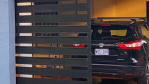 A black SUV parked inside a garage with a metal gate. - Congo House. Cottage in Golfito (Golfito)