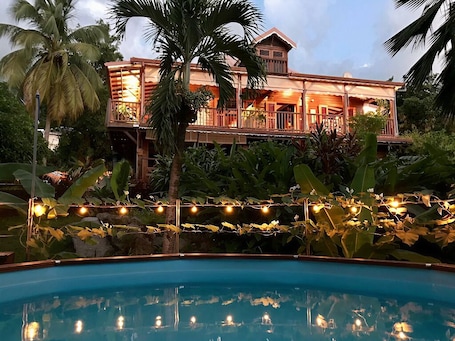 A large house with a pool, surrounded by tropical vegetation.. Top of creole villa with sea view, swimming pool, near Malendure - Bouillante