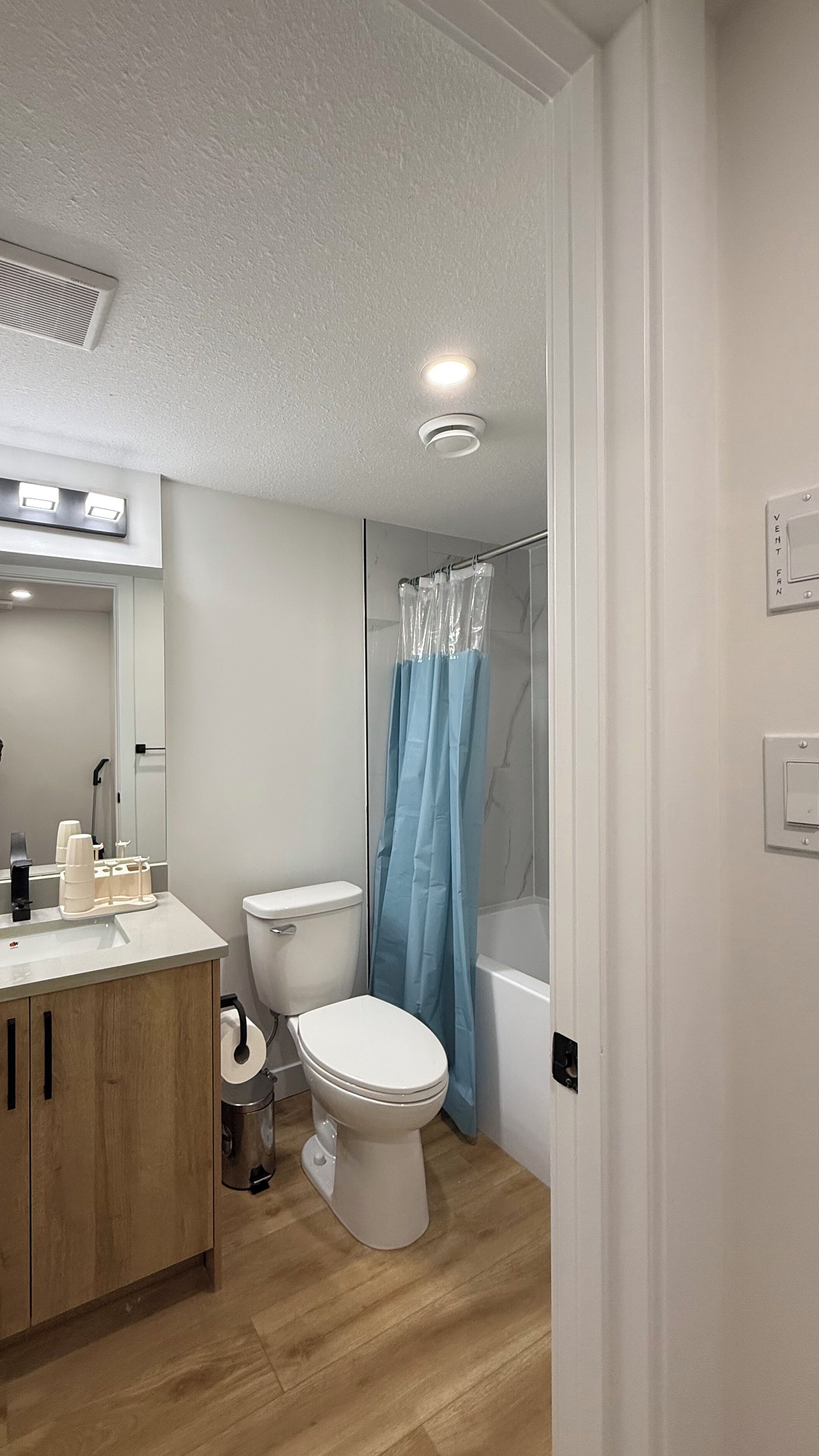 A modern bathroom with a toilet, sink, and shower area.