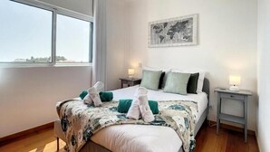 A hotel room with a large bed, two bedside tables, a world map artwork, and a window with a view. - Zen House By The Madeira Luxury Collection (Arco da Calheta)
