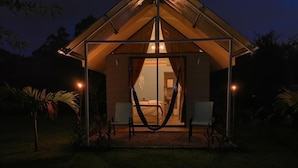A tent-style accommodation with a hammock, two chairs, and a visible interior. - The Dreamcatcher House (San Pedro)