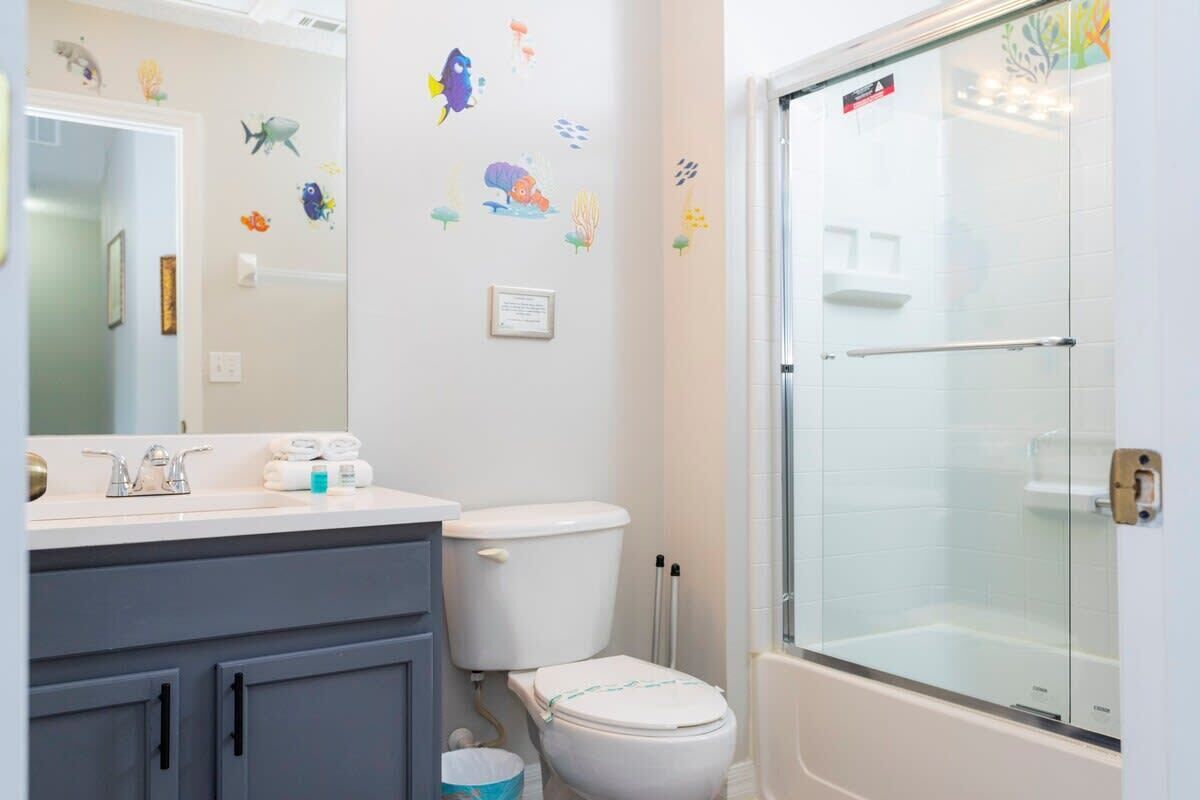 A bathroom with a toilet, a sink, and a shower.