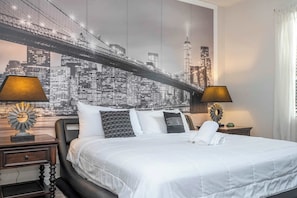 A hotel room with a bed, two bedside tables, a cityscape mural, and two lamps. - Spacious Family Retreat w/ Game Room & Steps to Clubhouse (Davenport)