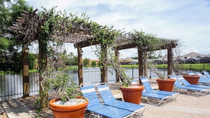 Eine Terrasse mit Liegestühlen und Topfpflanzen.
