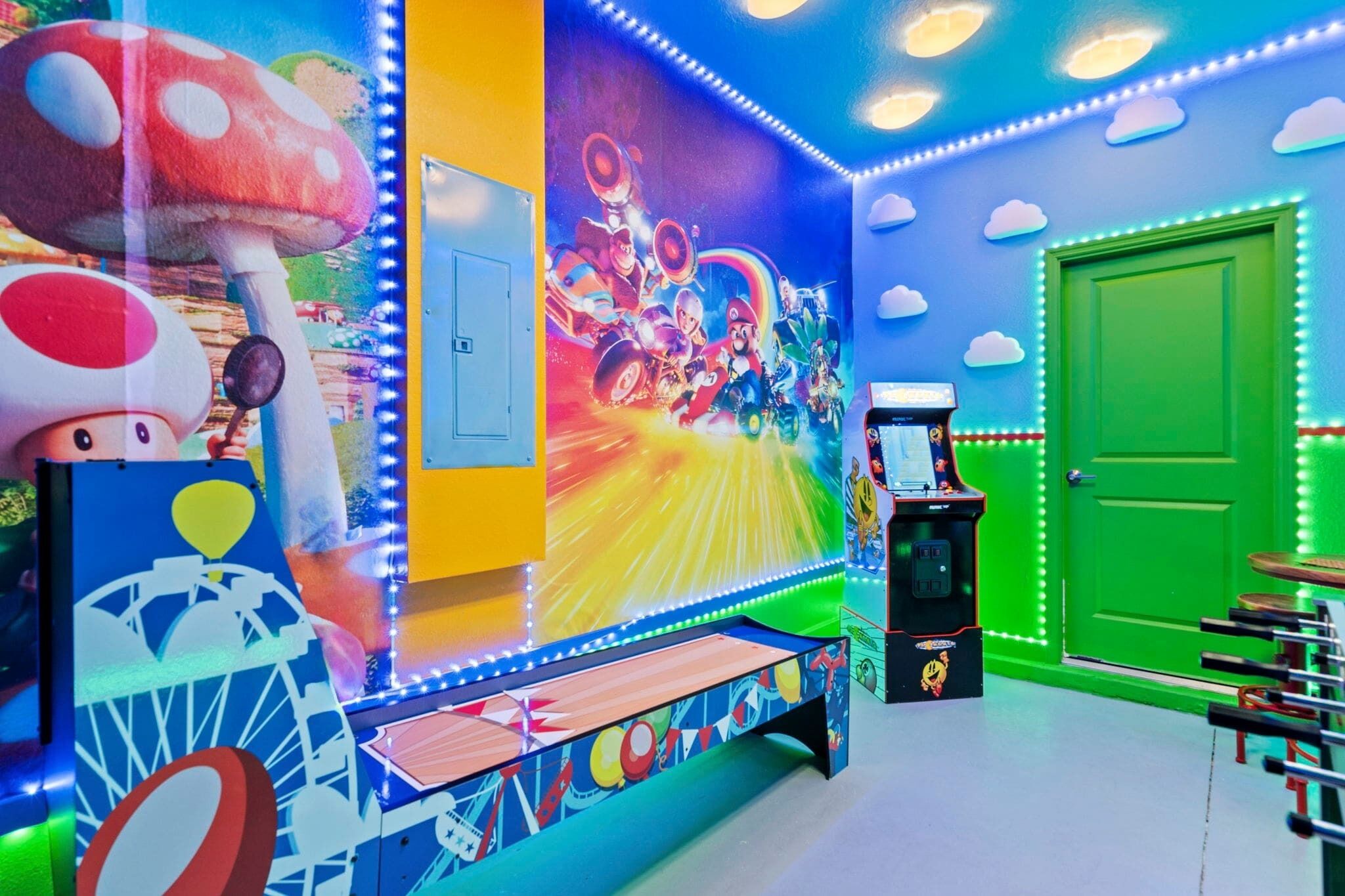 A brightly lit room with a mural of a racing game, a green door, and a small table with a toy car.