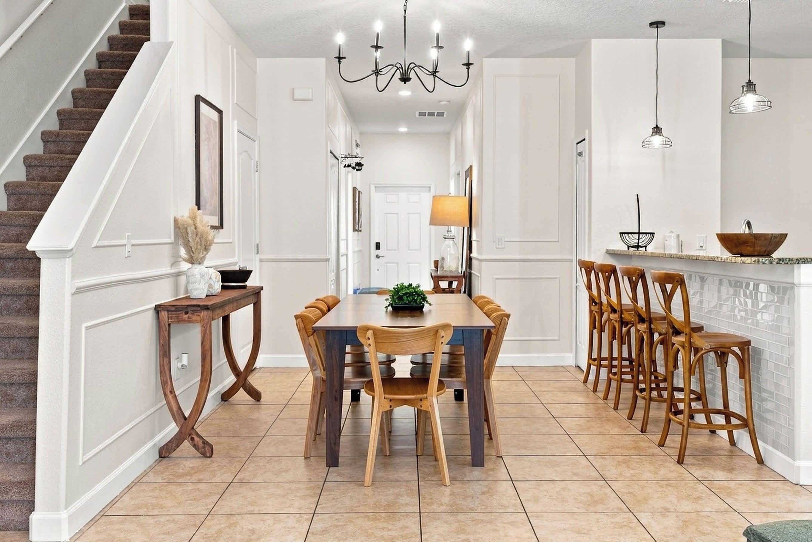 Une cuisine spacieuse avec un îlot central, des chaises en bois et une table à manger.