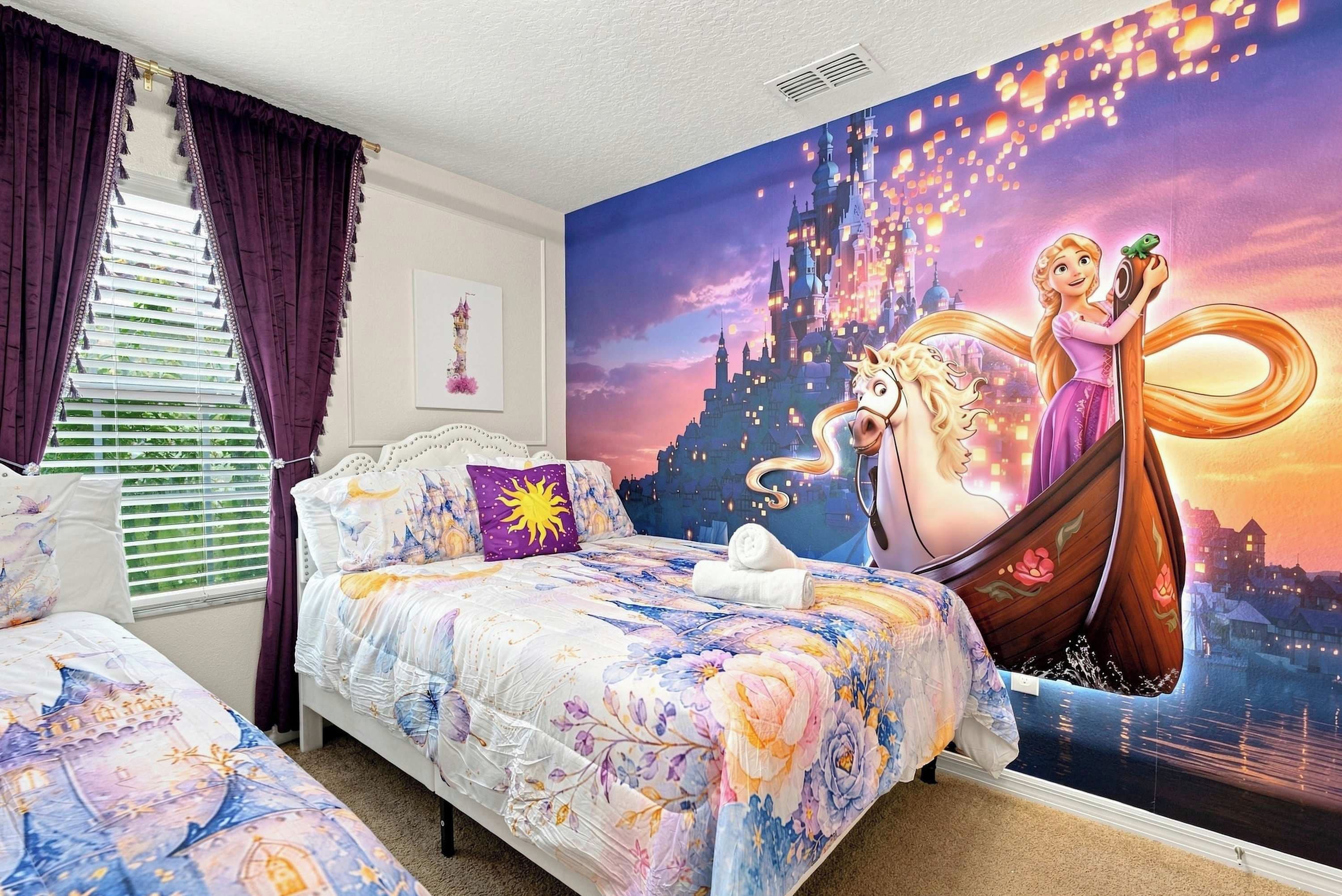 A bedroom with a large mural of a princess and a horse, a bed with floral bedding, and a window with curtains.