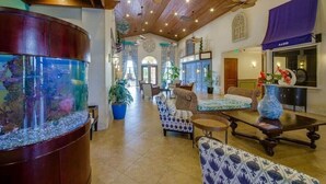 A spacious lobby with a large aquarium, comfortable seating, and a ceiling fan. - Family-friendly Paradise Palms Townhouse With Pool Access (Kissimmee)