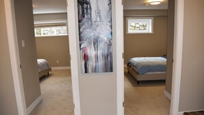 A bedroom with a bed, a window, and a door.