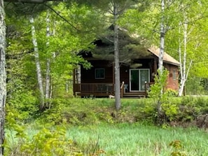 A cabin surrounded by trees.
