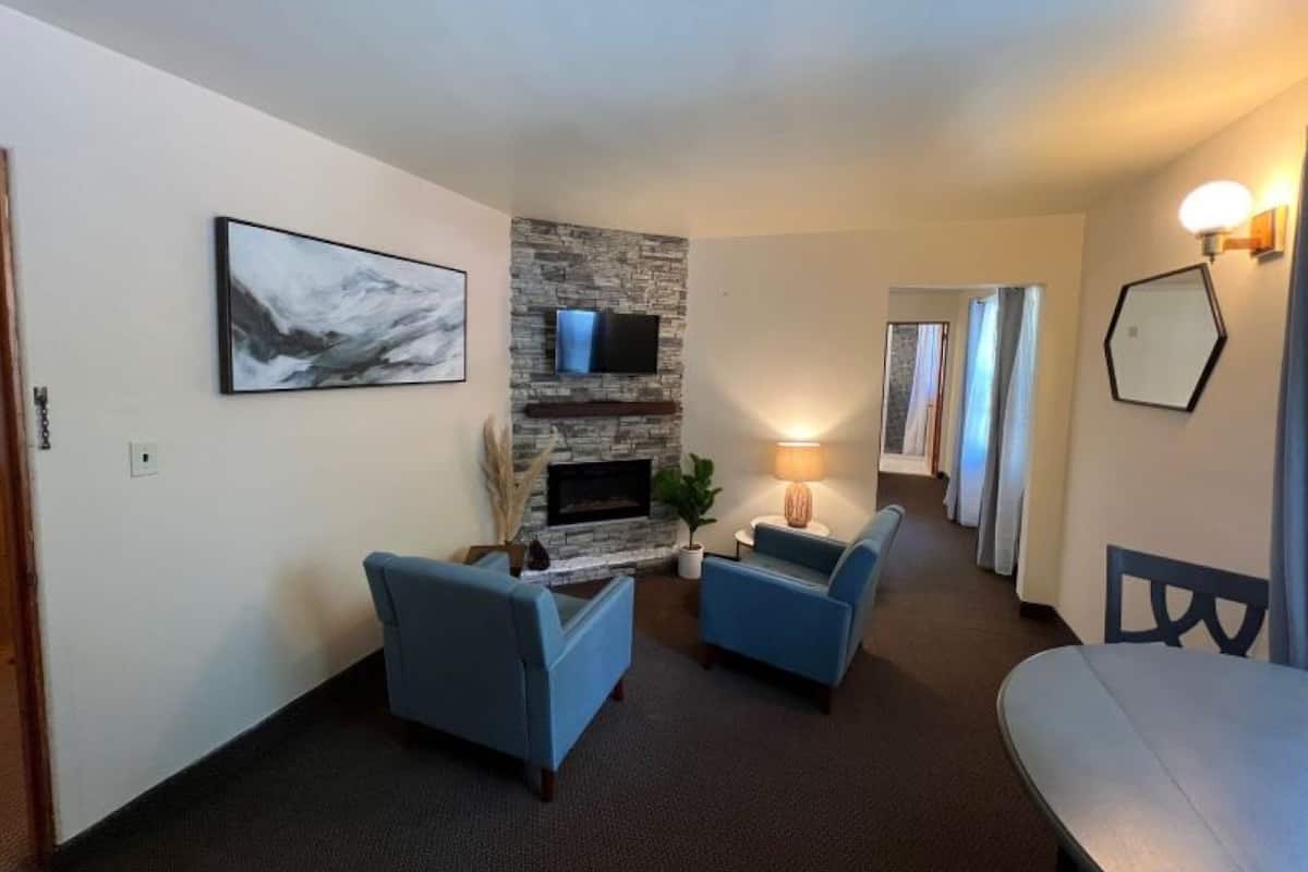 Deluxe Quadruple Room, 2 Double Beds | Living area | Fireplace