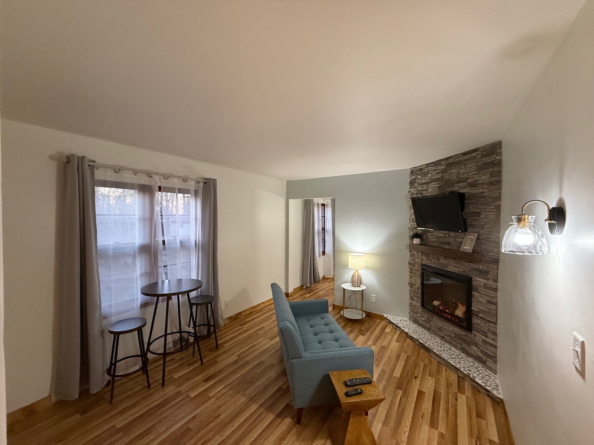 Deluxe Quadruple Room, 2 Double Beds | Living area | Fireplace