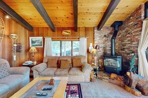 A cozy living room with a sofa, a coffee table, and a fireplace. - A Peaceful Destination in Mammoth Lakes (Mammoth Lakes)