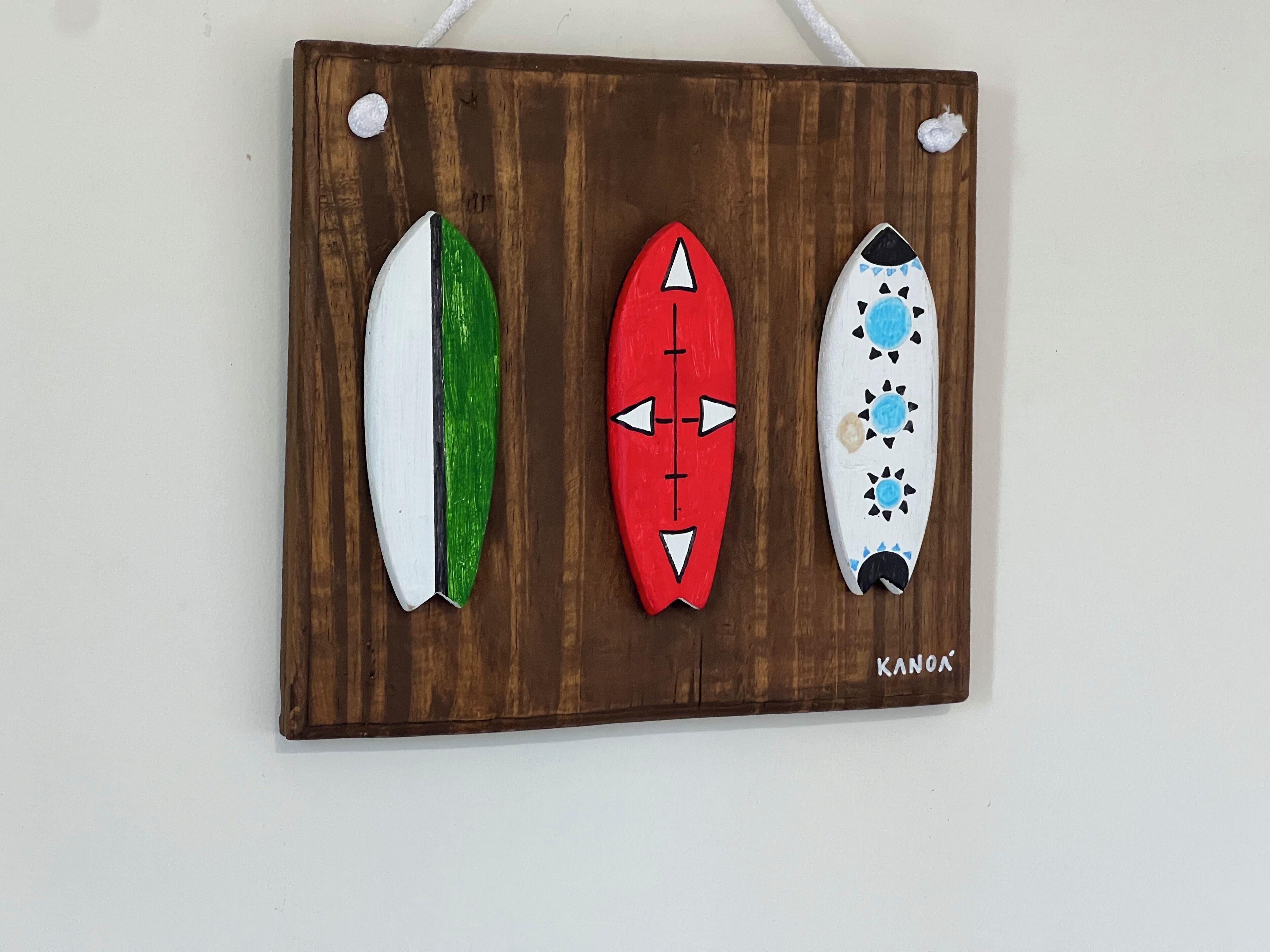 A wooden board with three surfboards.