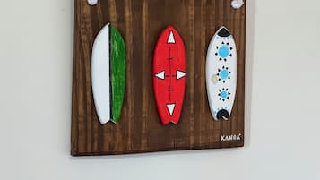 A wooden board with three surfboards.