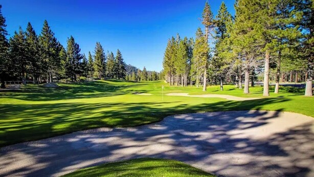 A golf course with a clear path, sand bunkers, and trees. - Comfy Condo Close to Skiing with Fireplace, Seasonal Pool, Hot Tub, & WiFi (Mammoth Lakes)