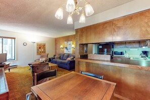A modern kitchen with wooden cabinets, a microwave, and a coffee maker. - Charming mountain condo w/ shared pool, hot tub, & easy slope access (Mammoth Lakes)