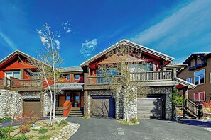 A multi-story house with a stone facade, a balcony, and a garage. - Mountain View Condo in Old Mammoth w/ Balcony, Fireplace & 3 Shared Hot Tubs (Mammoth Lakes)